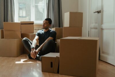 Person thinking while sitting among boxes