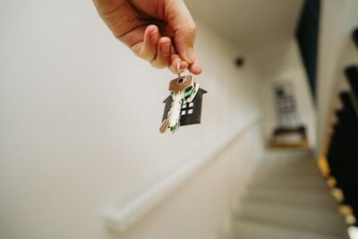 A person climbing the stairs while holding house keys
